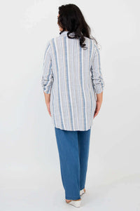 Back view of striped oversized tunic shirt worn with blue pants
