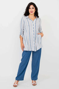 Full front view of model in striped bamboo/linen tunic and blue pants