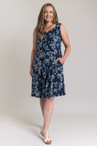 Women's indigo print summer sleeveless dress with pockets and round neckline.